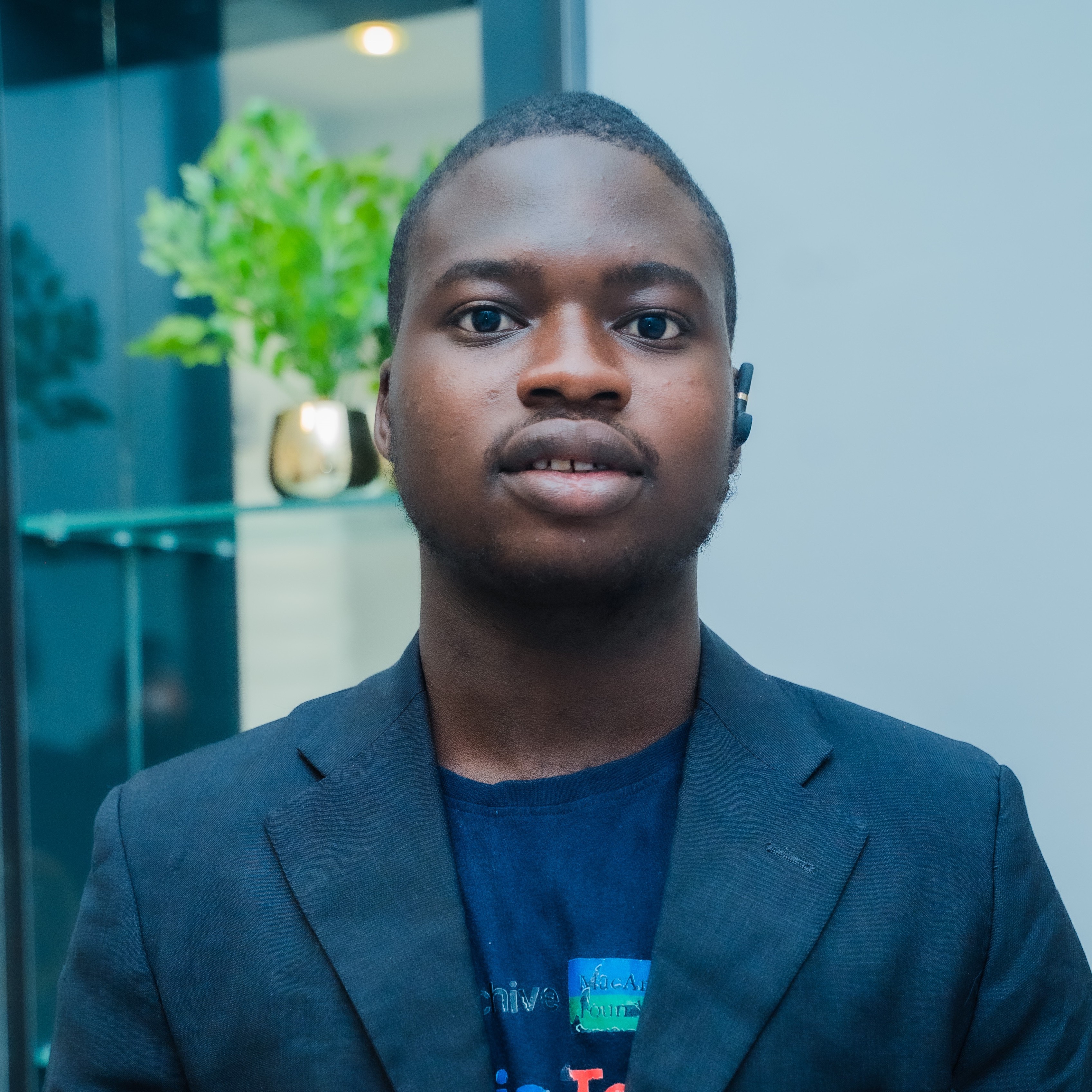 A portrait of a young man dressed in corporate suite.