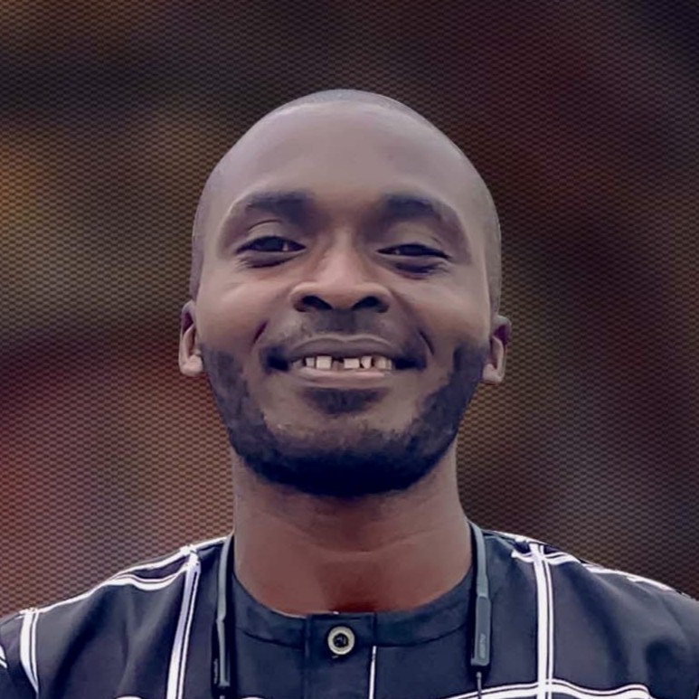 A portrait of a young man smiling.