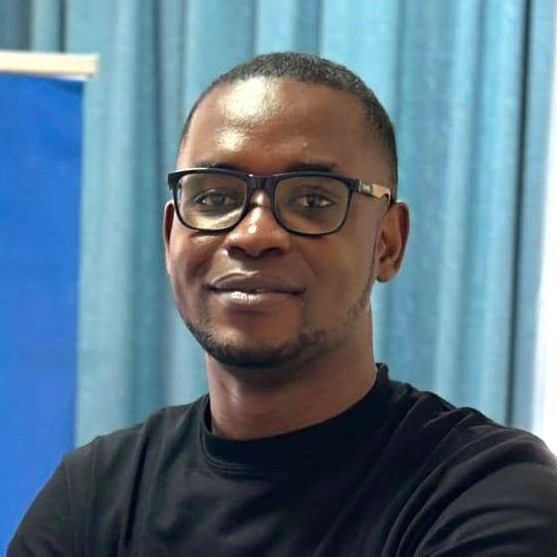 A portrait of a young man folding his arms.