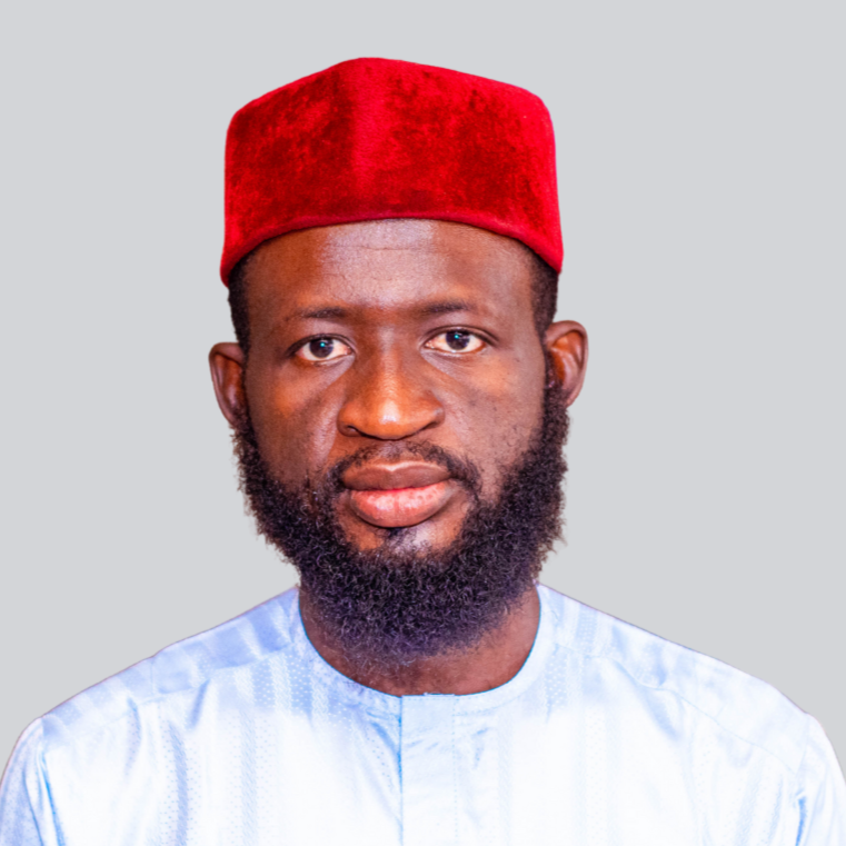 A portrait of a young man dressed in red cap and white regalia